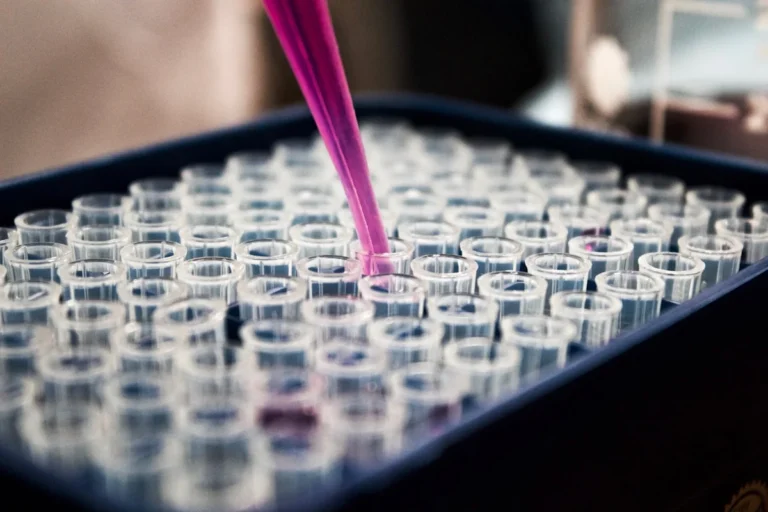 Pharmaceutical laboratory with molecular research visualization — AI drug discovery accelerates protein folding analysis and