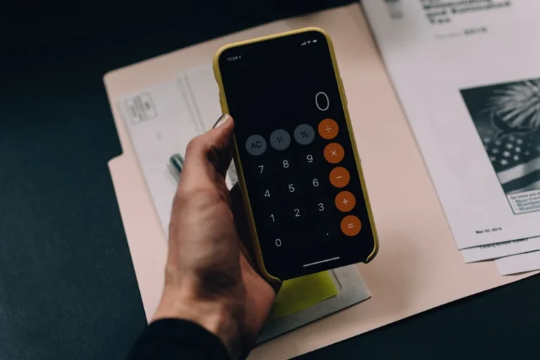 Freelancer reviewing financial dashboard with AI accounting tools on laptop — automated invoicing expense tracking and tax p