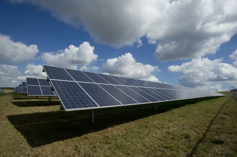 Solar panels and wind turbines in renewable energy farm — AI optimization improves output from solar and wind energy install