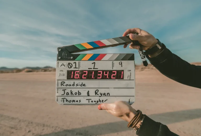 YouTube creator filming video with professional camera setup using AI production tools 2026