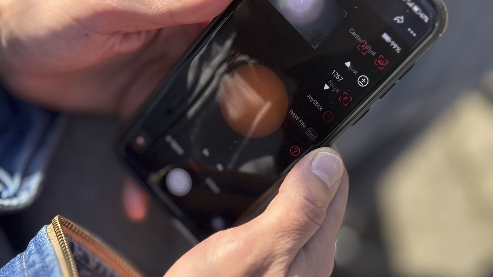 Person using a smartphone camera app outdoors, representing AI visual search