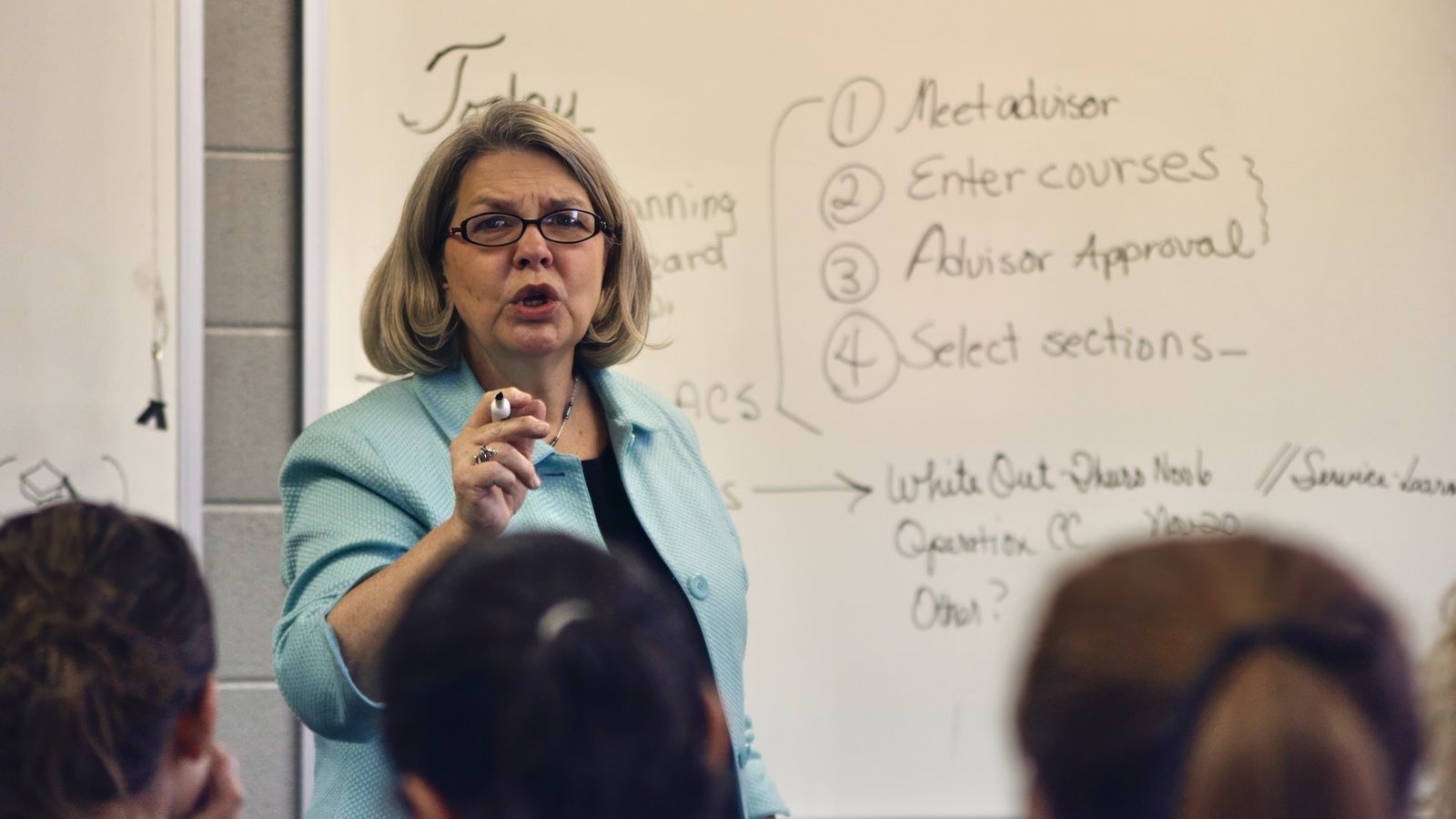 A college professor teaching in a university classroom