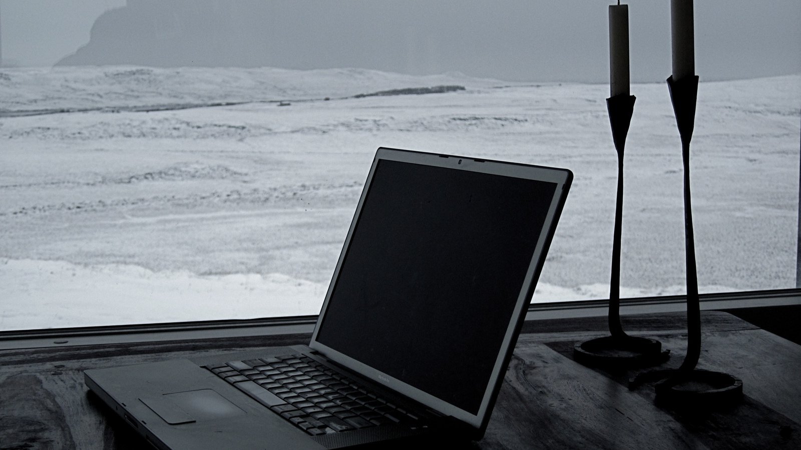 Laptop open alone on a table, representing solo freelance work