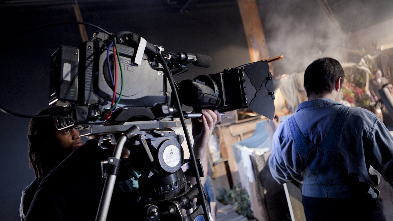 Film production crew operating a camera on set