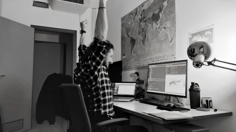 Programmer working at a multi-monitor desk setup